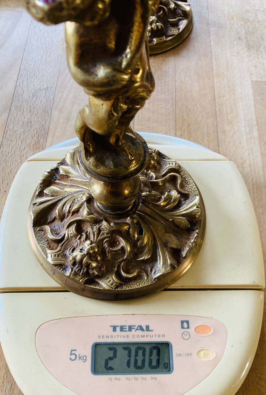 Solid bronze candlesticks decorated with putti, acanthus leaves and lion heads