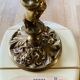 Solid bronze candlesticks decorated with putti, acanthus leaves and lion heads