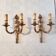 Pair of Louis XV style rocaille two-armed sconces in gilded bronze