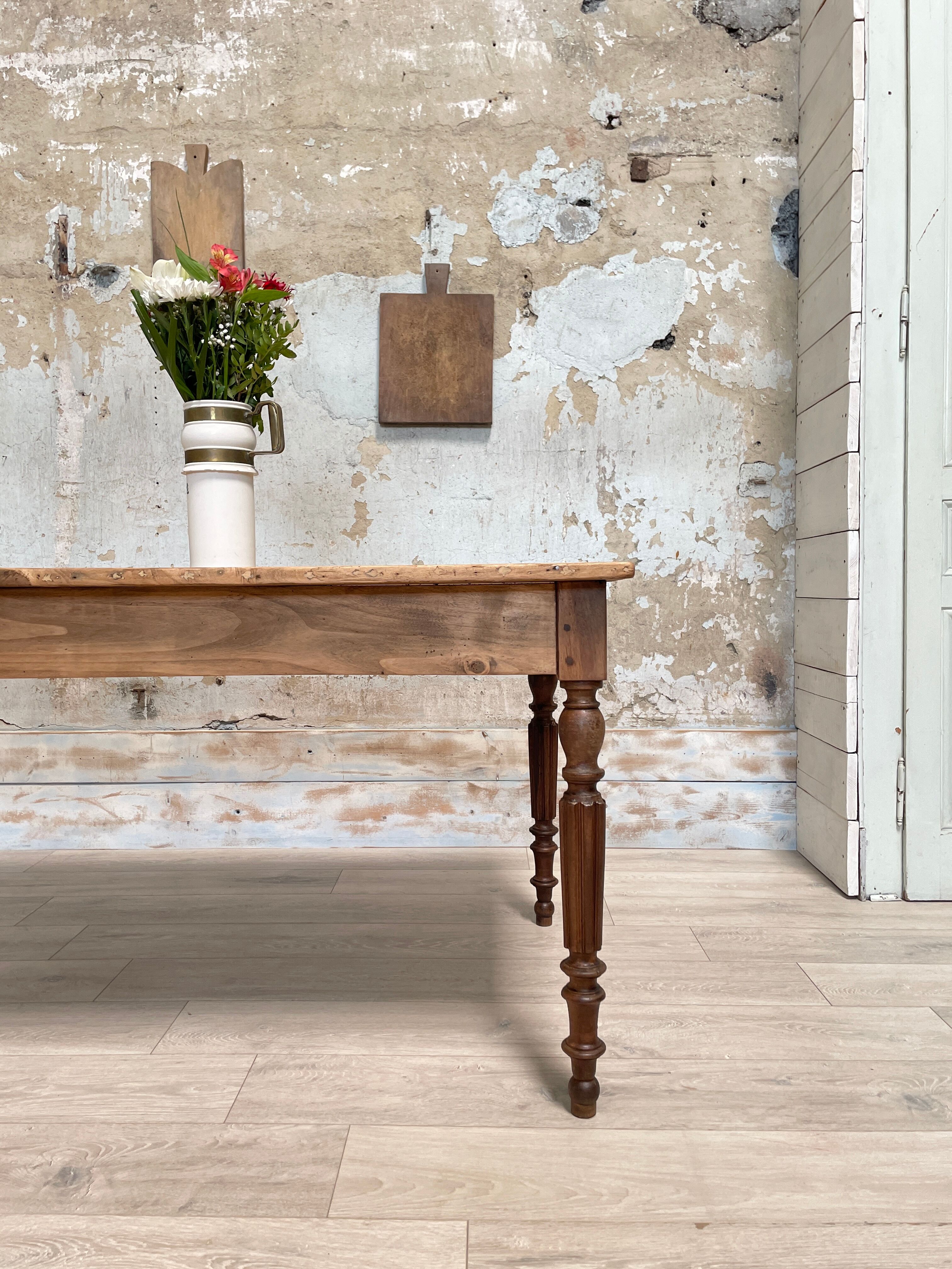 Vintage farmhouse table with turned legs.