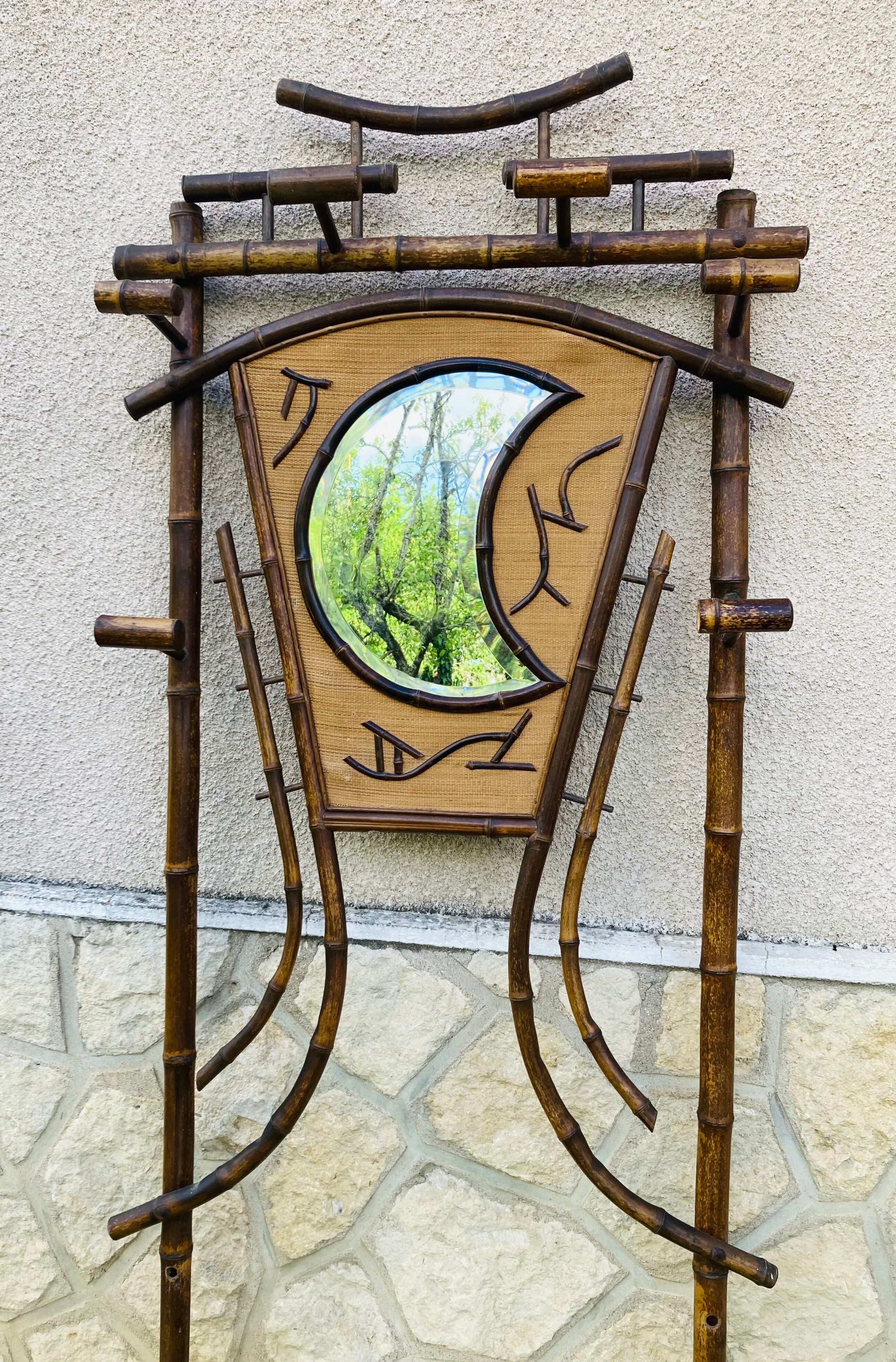 Bamboo coat rack from the 19th century, mirror in the shape of a crescent moon.
