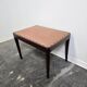 Vintage wooden ottoman from the 1940s with a silk top and studded trim.