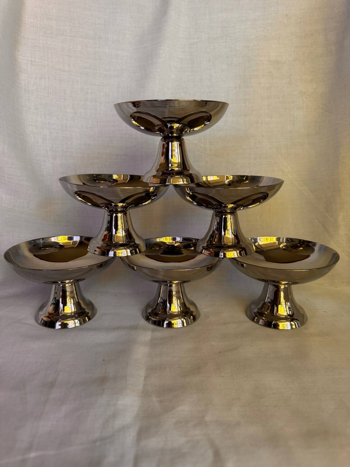 Set of 6 stainless steel ice cream bowls by Guy Degrenne with matching spoons.