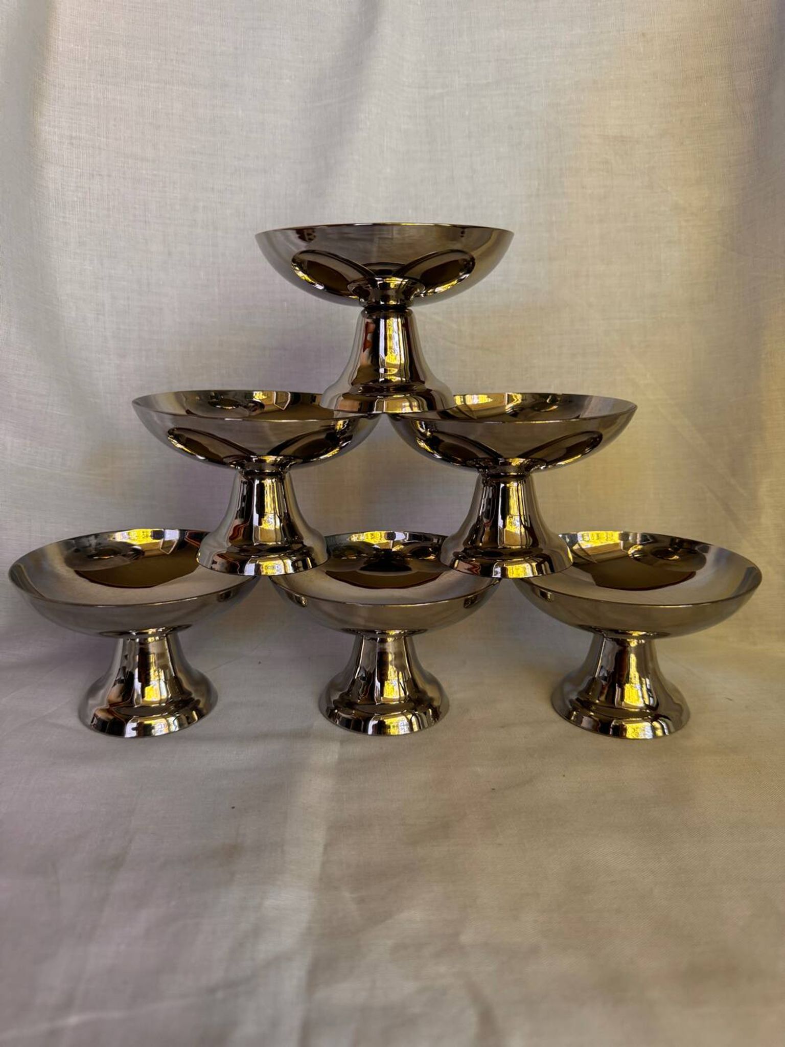 Set of 6 stainless steel ice cream bowls by Guy Degrenne with matching spoons.