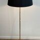 Brass floor lamp with a tripod base and claw feet from Maison Jansen.