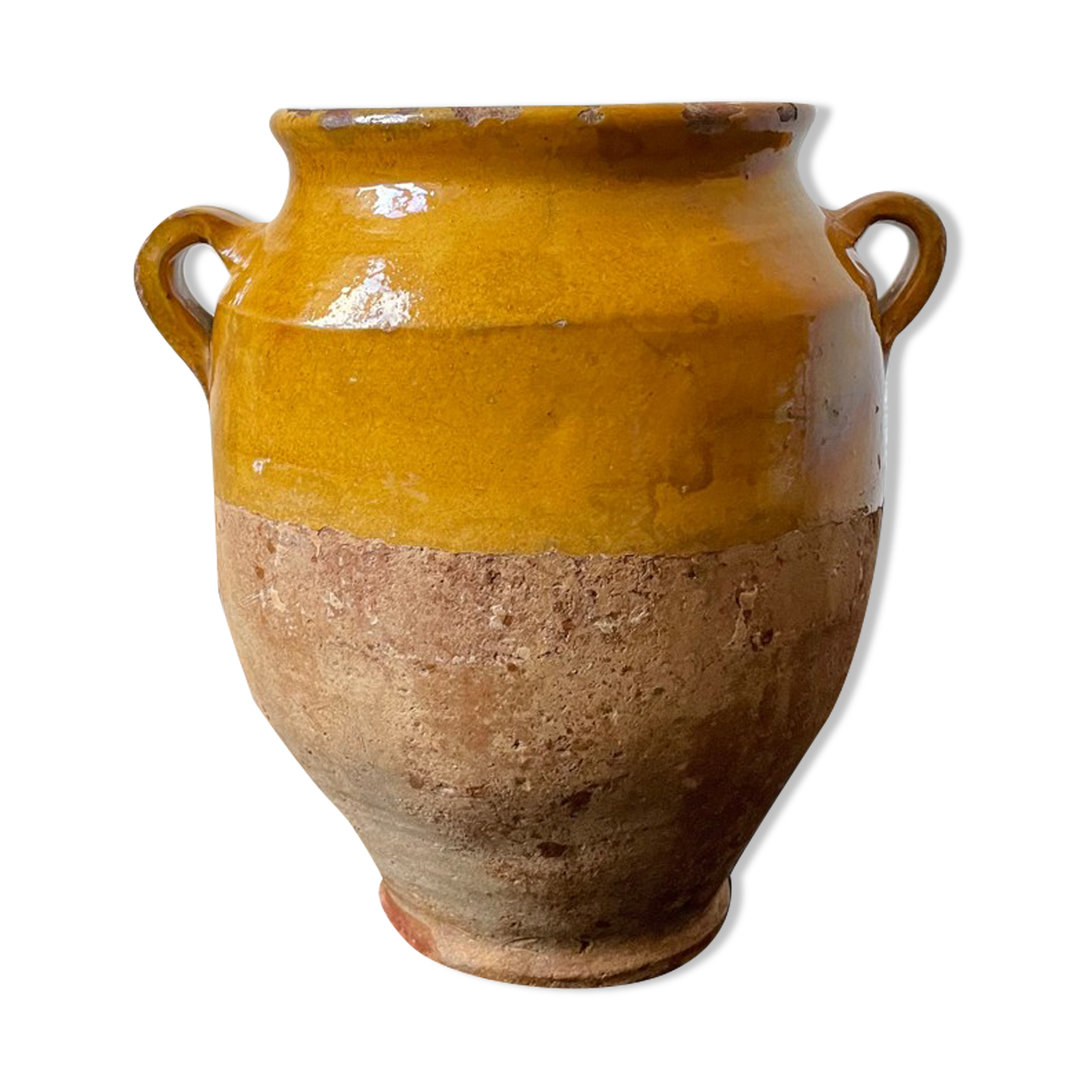 Old candied pot in yellow glazed terracotta