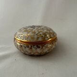 White and golden pill box with a blue bird
