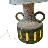 Vintage ceramic floor lamp with illuminated base.