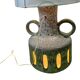 Vintage ceramic floor lamp with illuminated base.