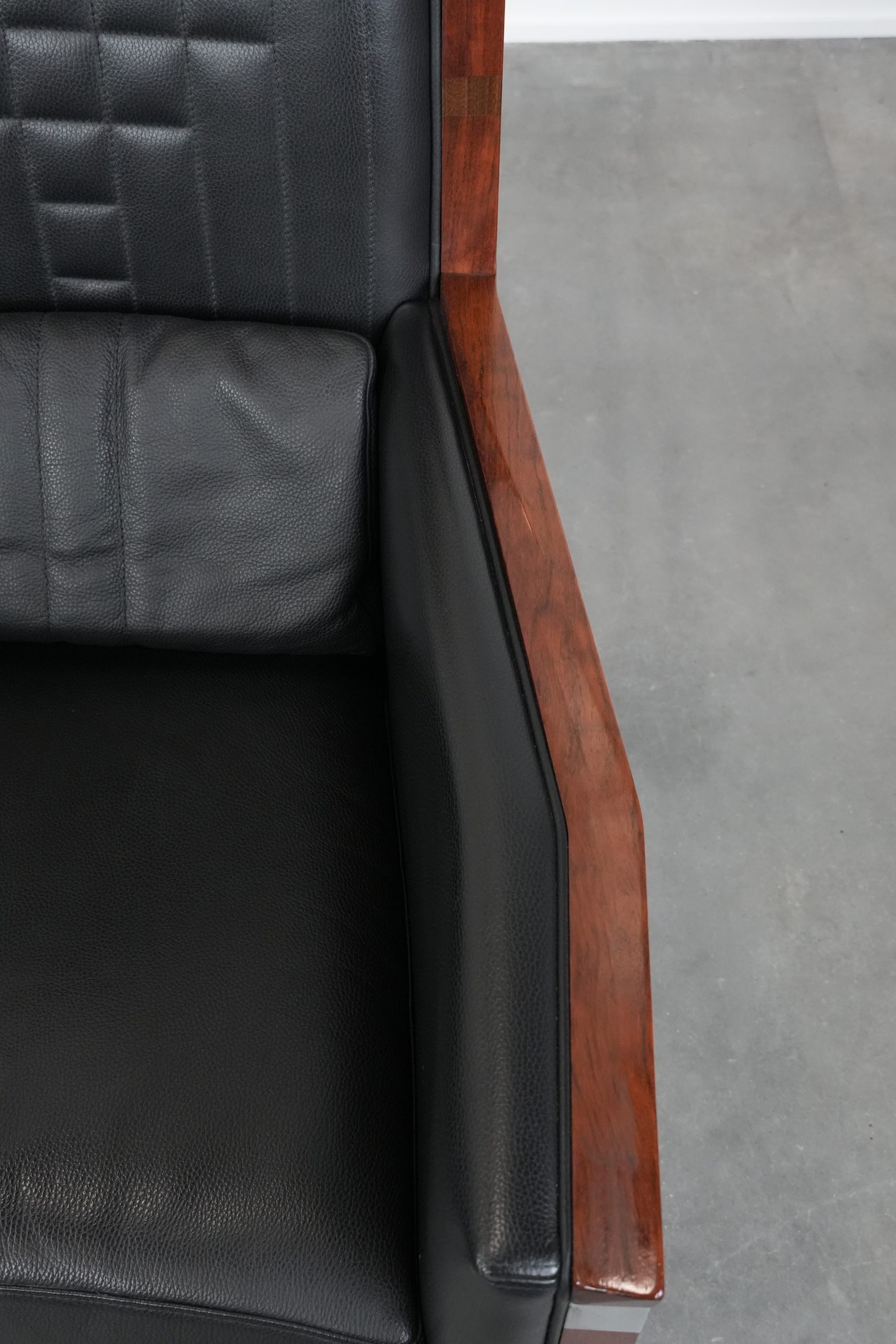 Art Deco design armchair with black leather with decorative stitching