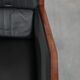 Art Deco design armchair with black leather with decorative stitching