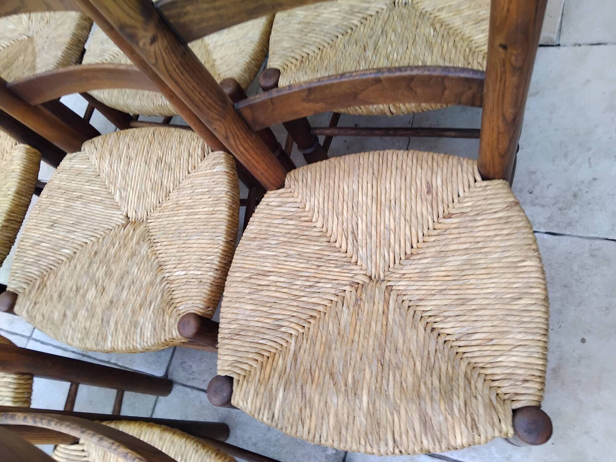 8 vintage straw chairs in the style of Charlotte Perriand.