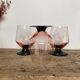 4 pink glasses with black stems