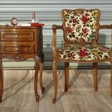 Convertible armchair with brocade fabric and floral patterns.