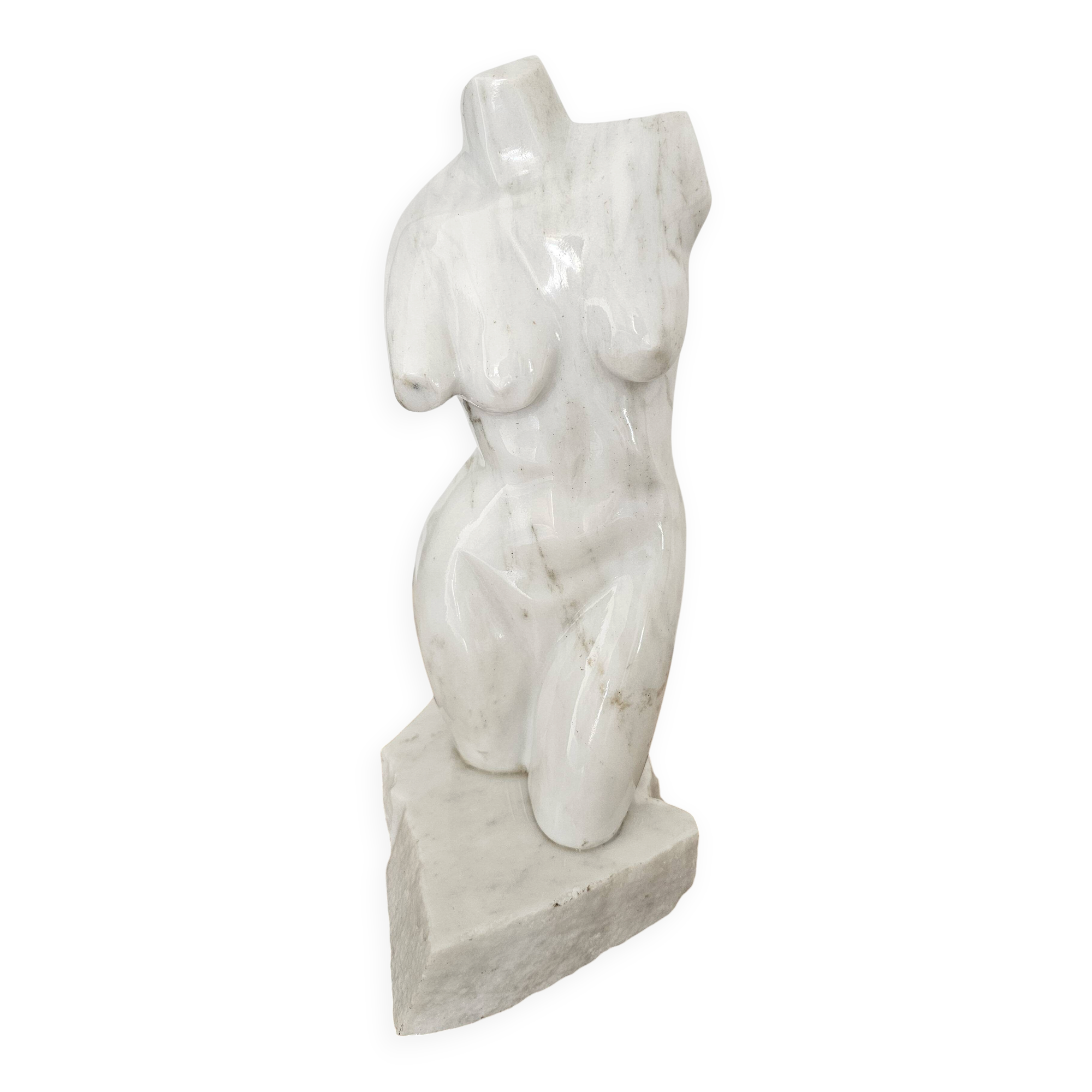 Sculpture of a female torso in white marble.