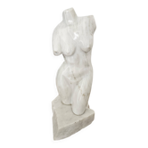 Sculpture of a female torso in white marble.