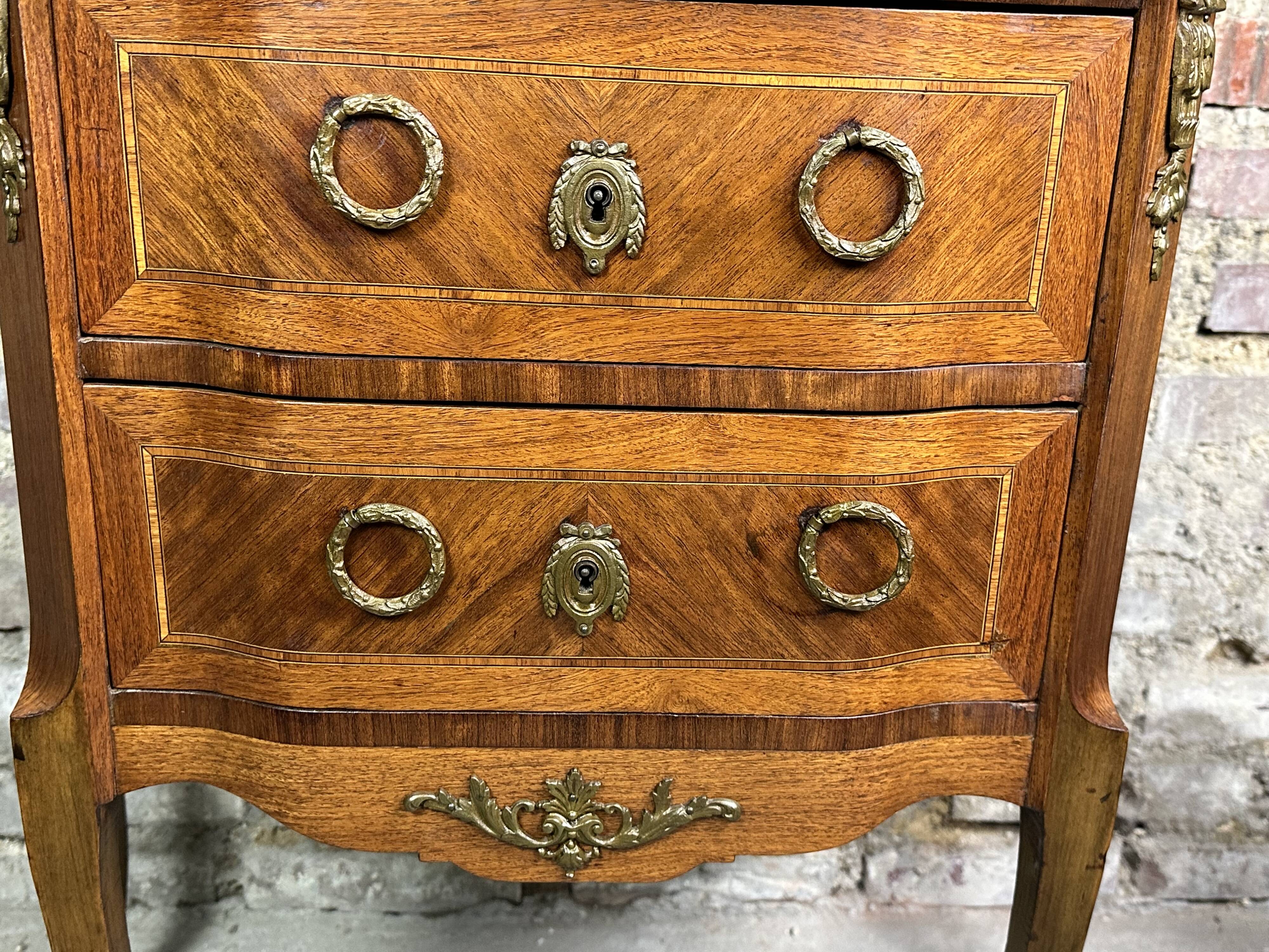 Louis XV/XVI transition style curved chest of drawers in marquetry and bronze