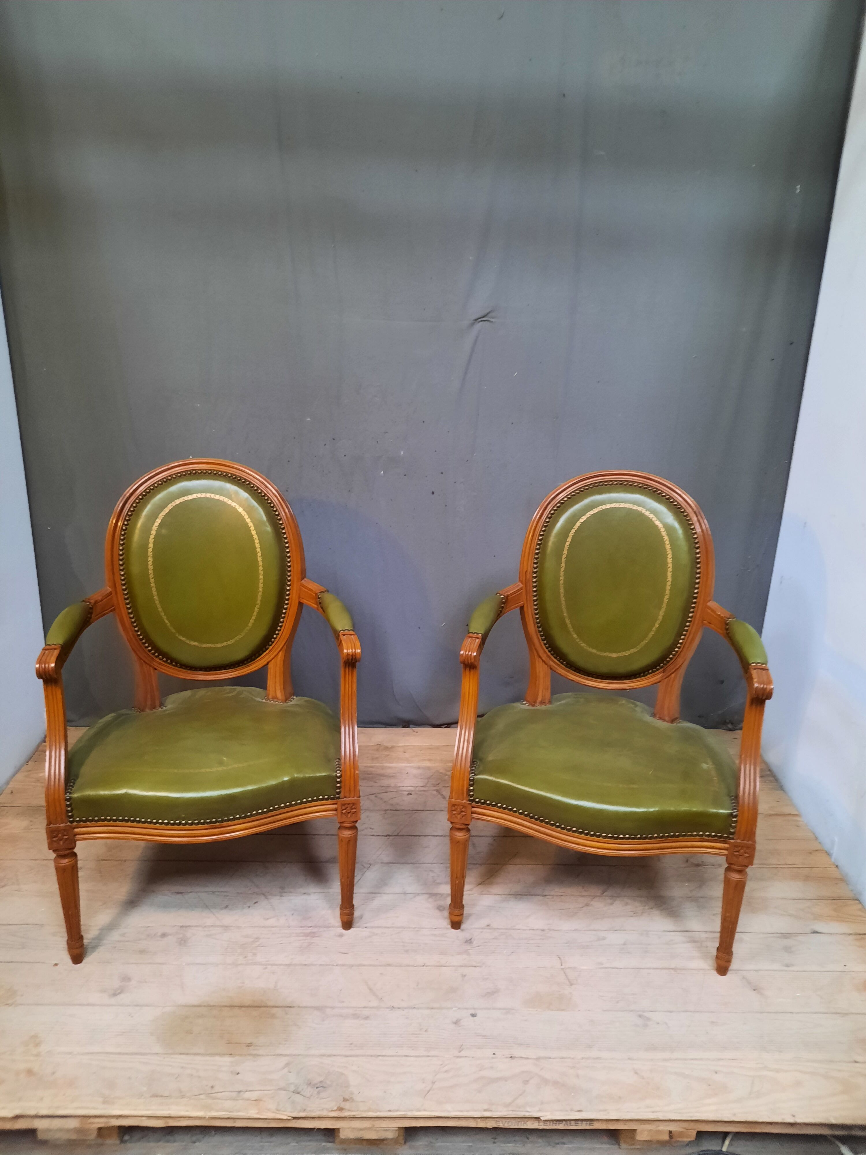 Pair of Louis XVI style leather armchairs