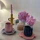 Set of ceramic artisan mugs with a pop of petrol blue water lily design.