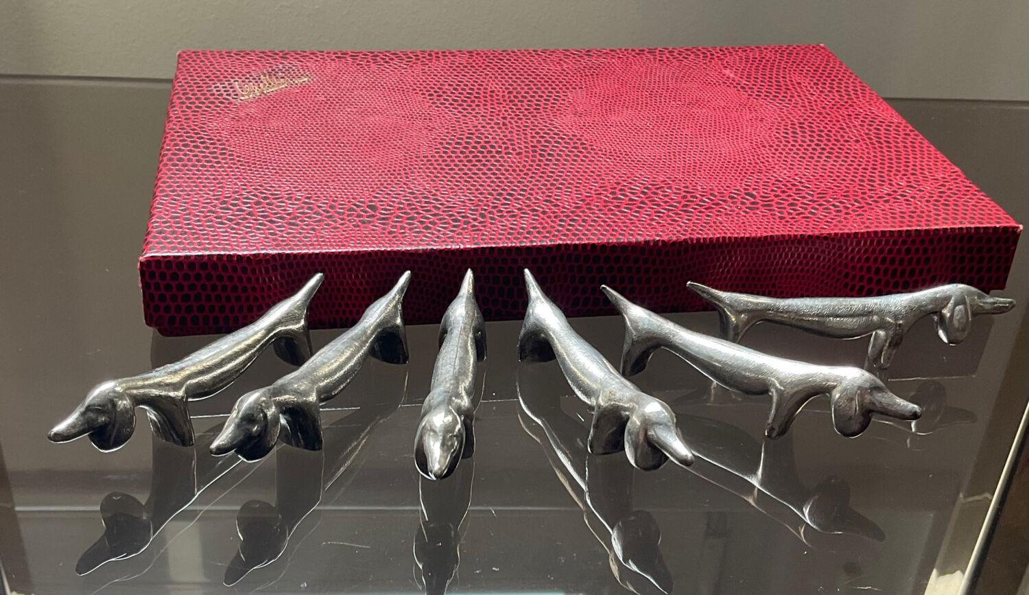 Series of vintage Dachshund knife holders in silver metal