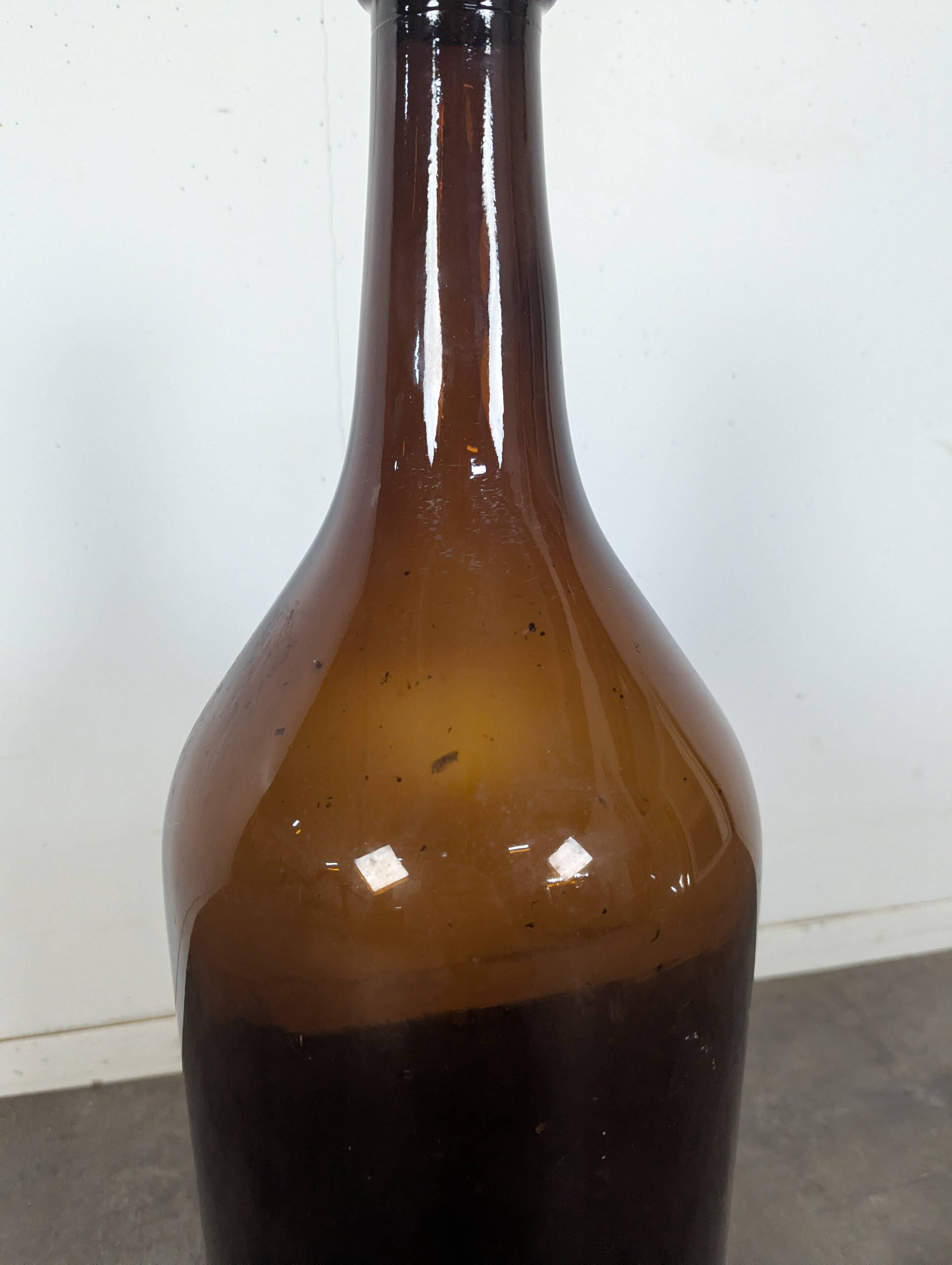 Large antique blown amber glass bottle