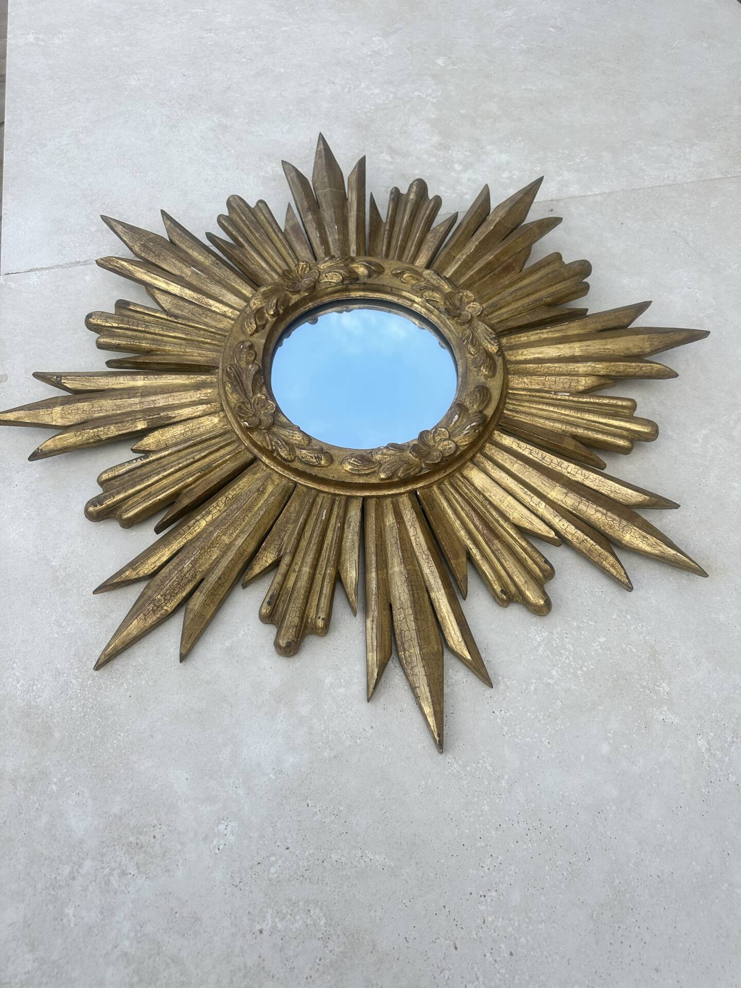 Large sun mirror in carved gilded wood.