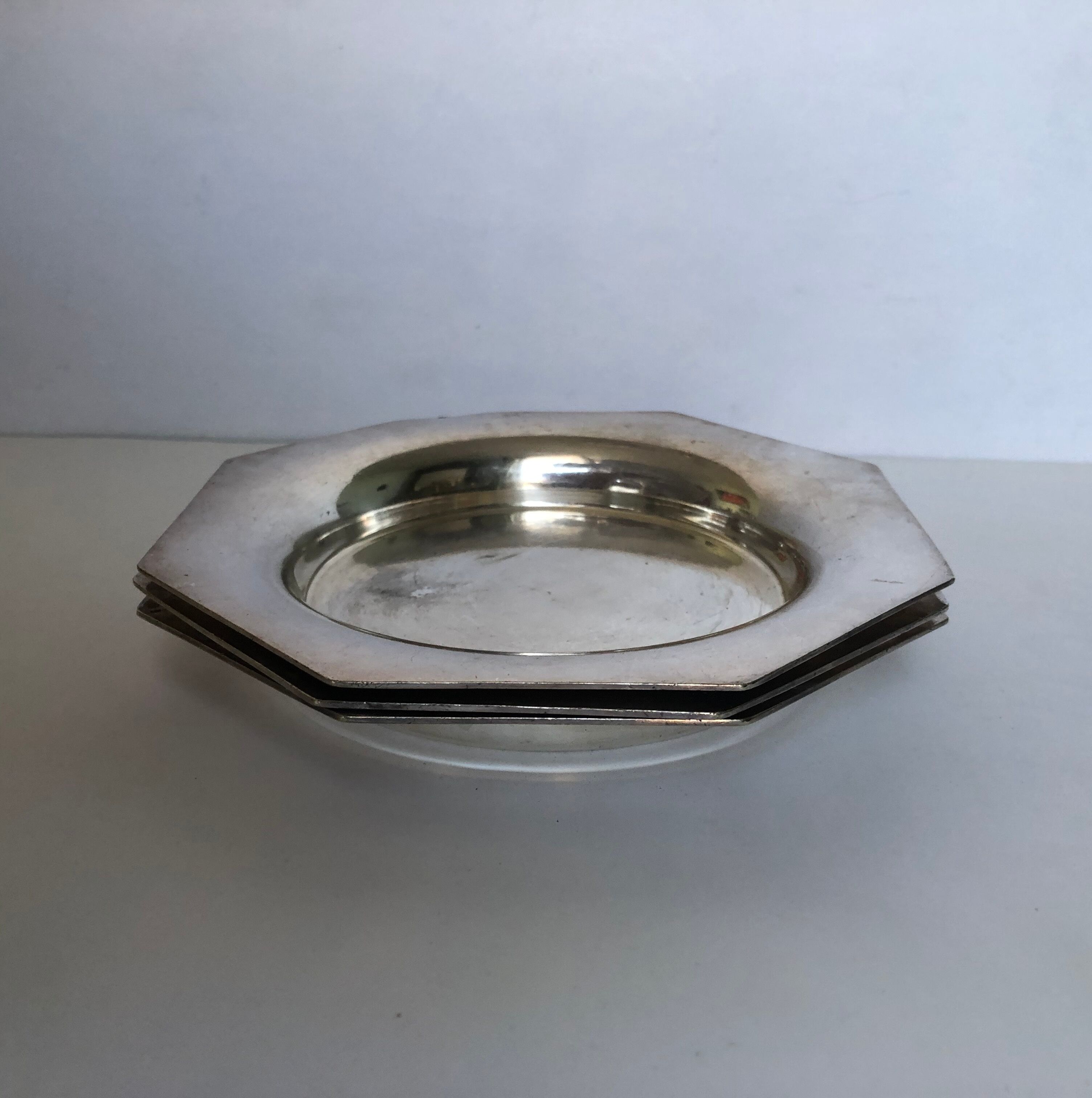 Set of three silver metal bottle bottoms