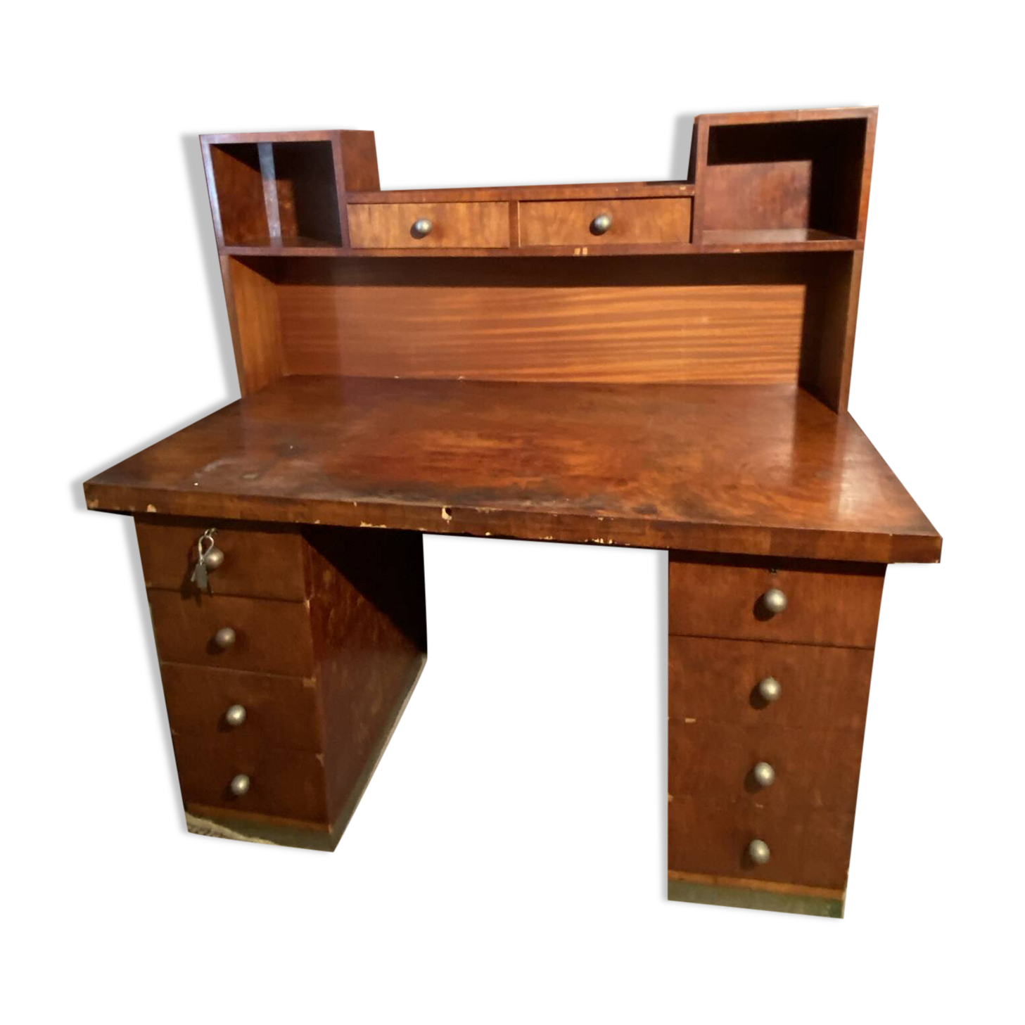 Vintage desk with drawers and a hutch with numerous drawers.