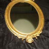 Ovoid mirror with double pediments gilded with leaf circa 1830, 105x66 cm