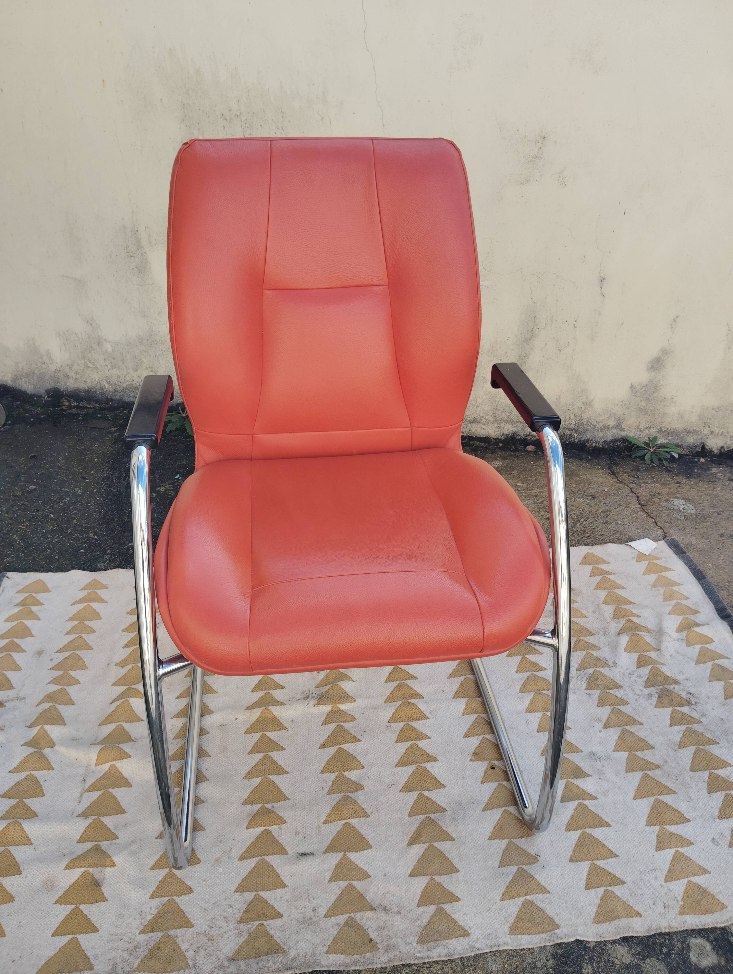 Orange leather cantilever tubular armchair