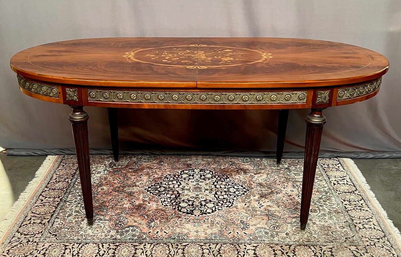 Louis XVI style oval dining table with rosewood marquetry extension mounted in bronze