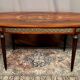 Louis XVI style oval dining table with rosewood marquetry extension mounted in bronze