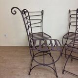 Series of four designer cast iron chairs with reversed backs and very beautiful x-legs