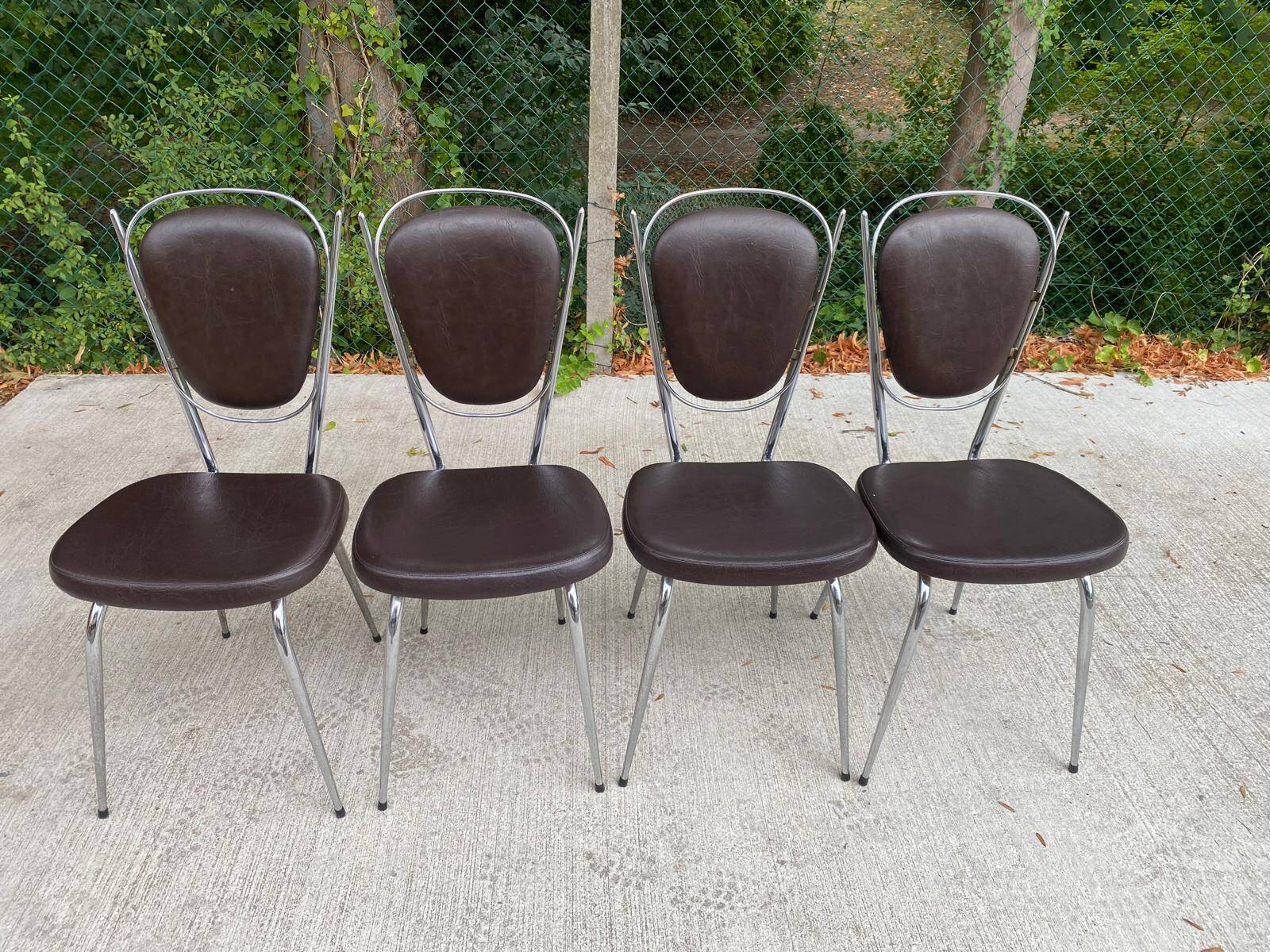Set of 4 vintage chairs from the 60s/70s in brown faux leather with chrome compass legs.