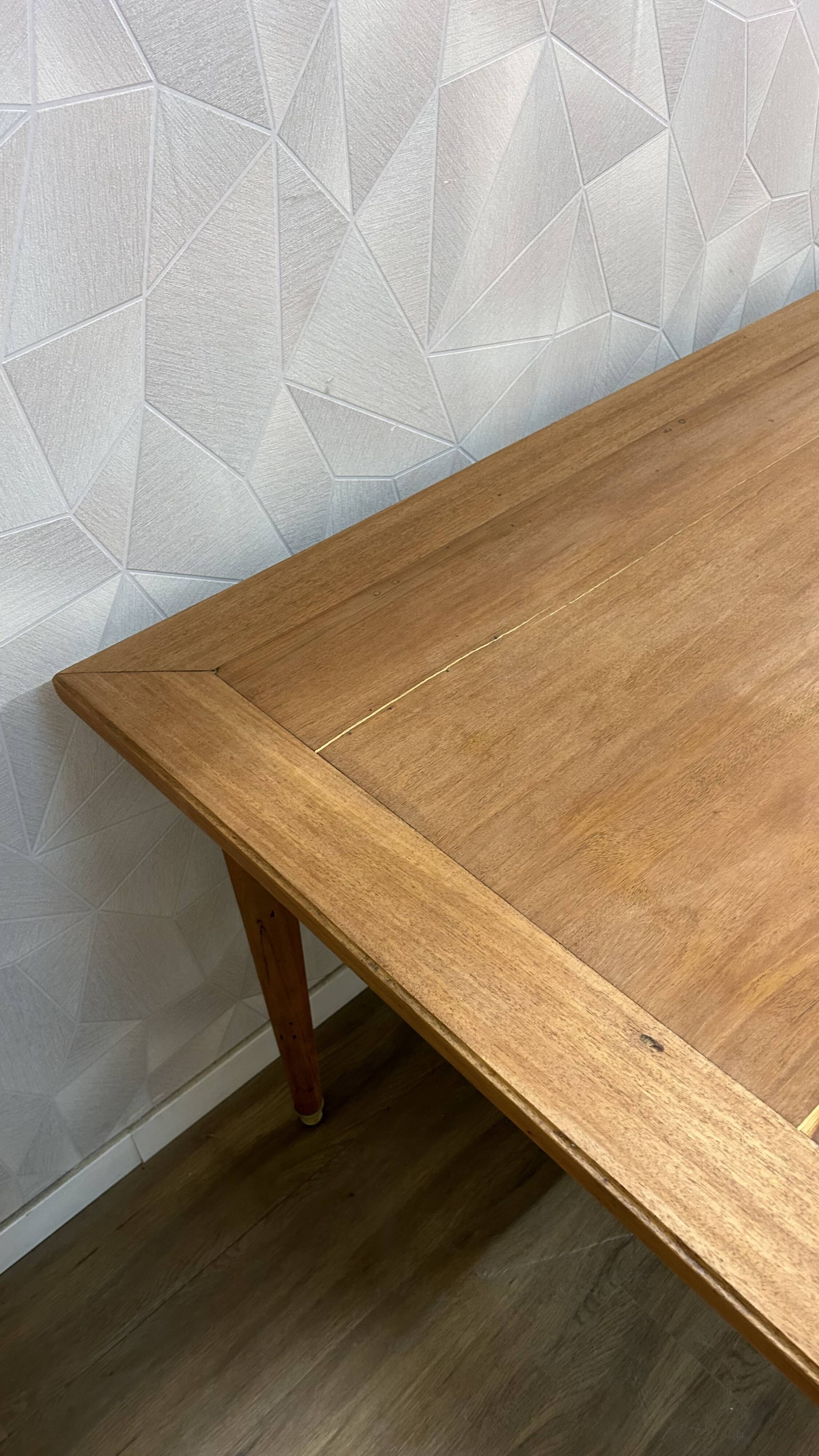 Dining table with tapered legs and solid exotic wood