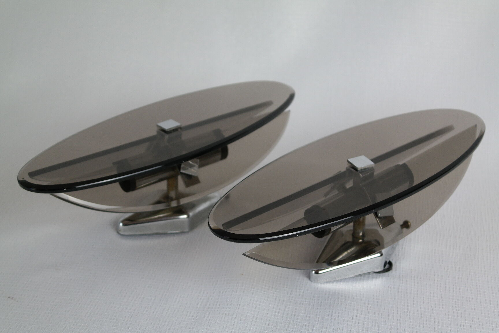 Pair of smoked glass and vintage chrome wall lamps