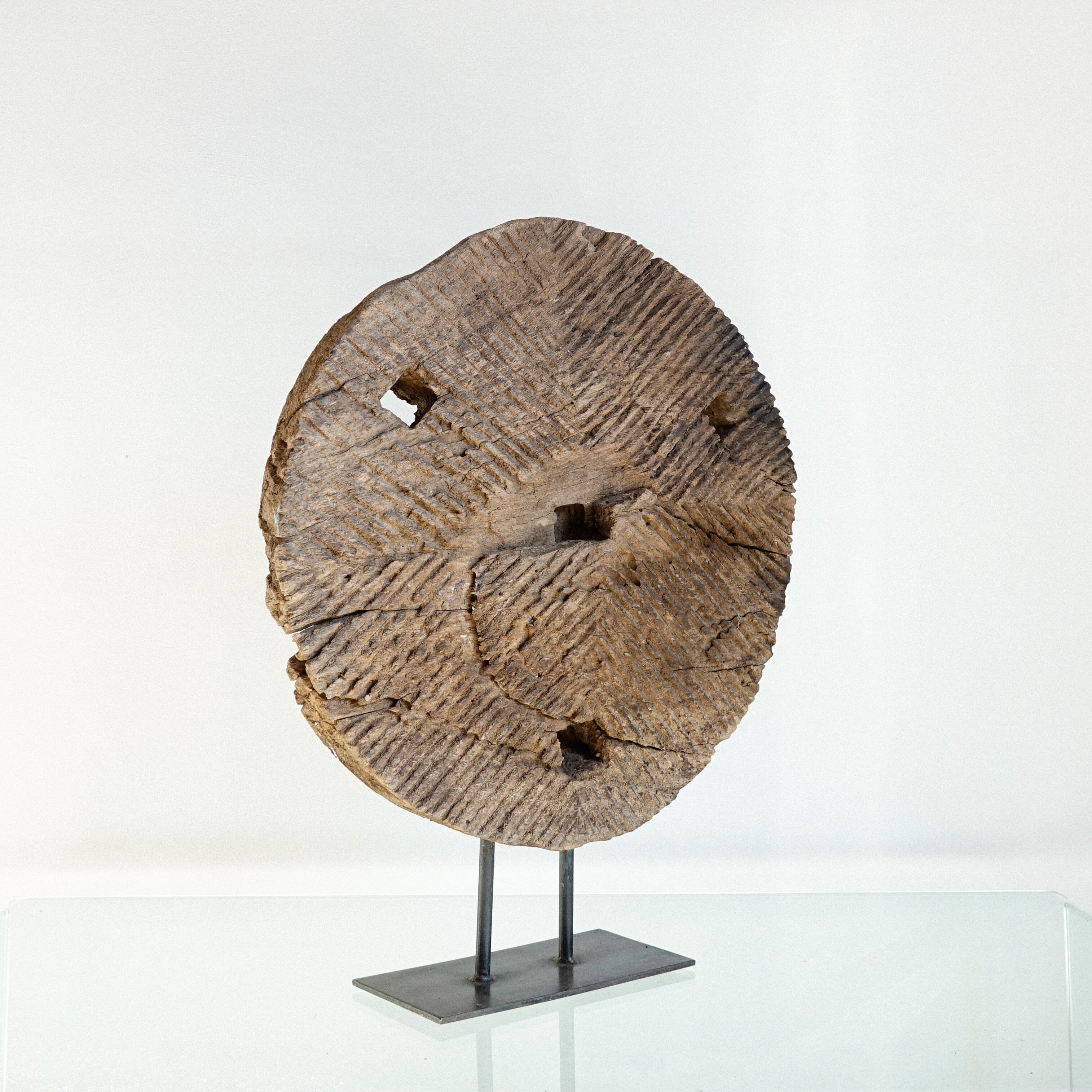 Old decorative wooden wheel on foot