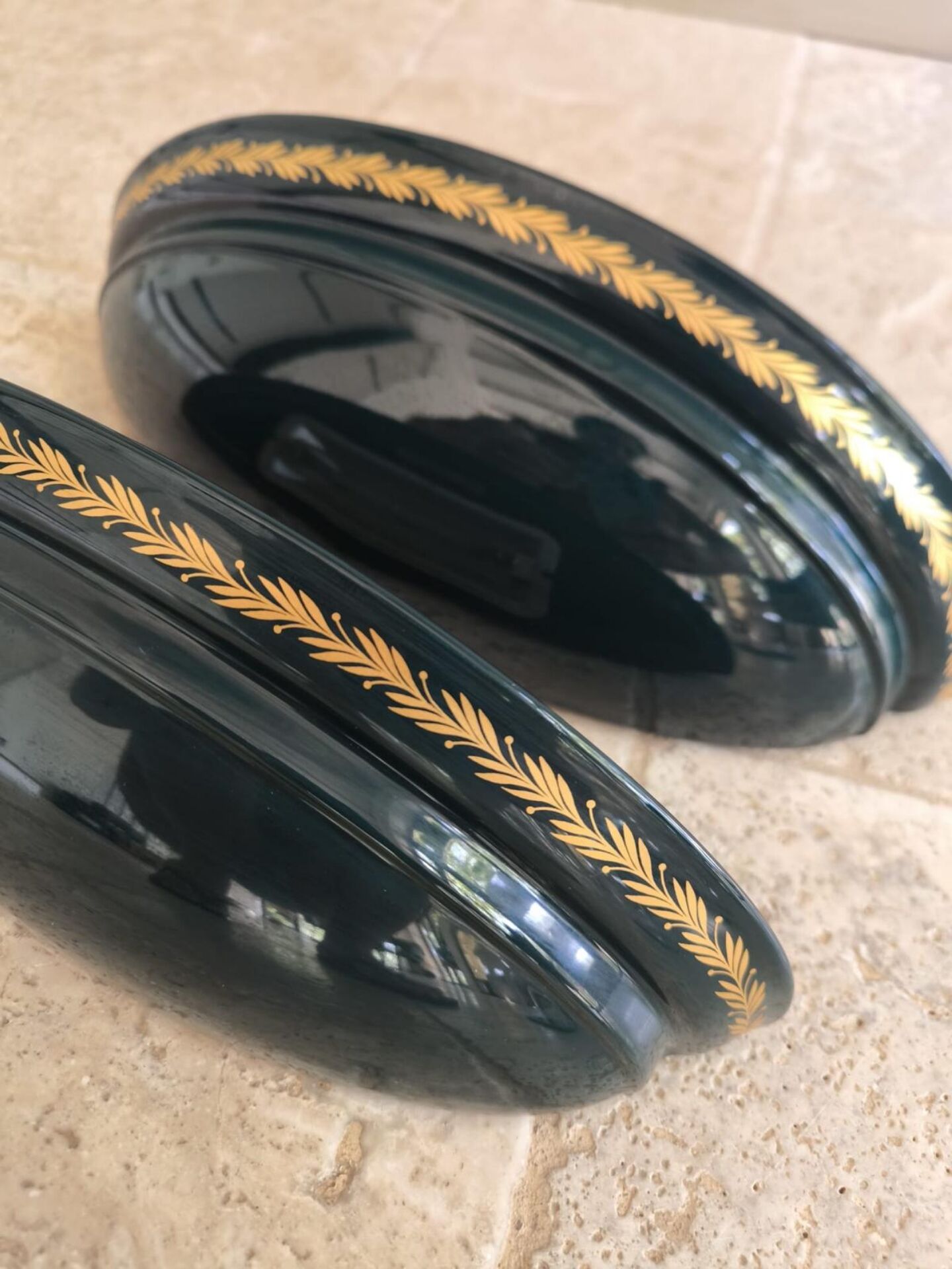 Set of two vintage wall sconces in pine green and gold.