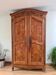 Large cherry wood wardrobe in sculpted provincial Louis XV style.