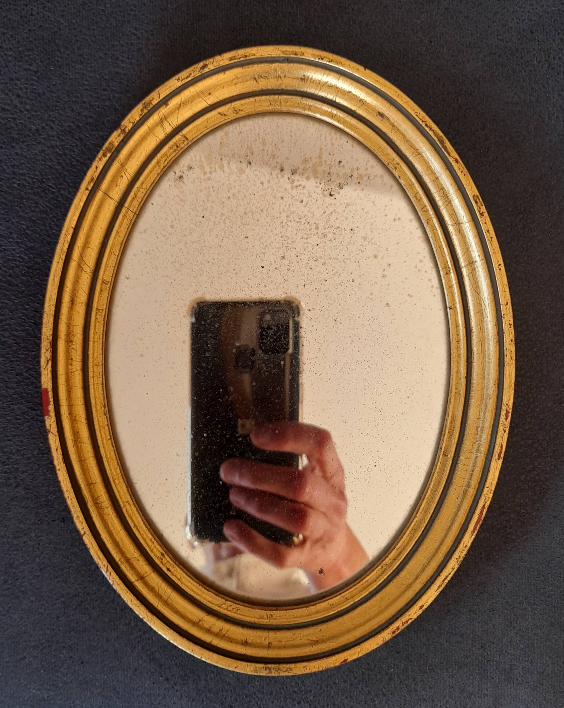 Old golden oval mirror