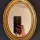 Old golden oval mirror