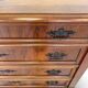 Antique walnut commode with bronze handles in the shape of a lion's mask,