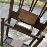 Antique brown wooden coat rack with mirror and umbrella stand, 1900 style.