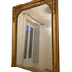 Nineteenth century mirror in wood and stucco gilded with rich gold leaf ornamentation, 101x127 cm