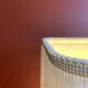 Beige marble stucco base, Houles white ecru fringed lampshade.