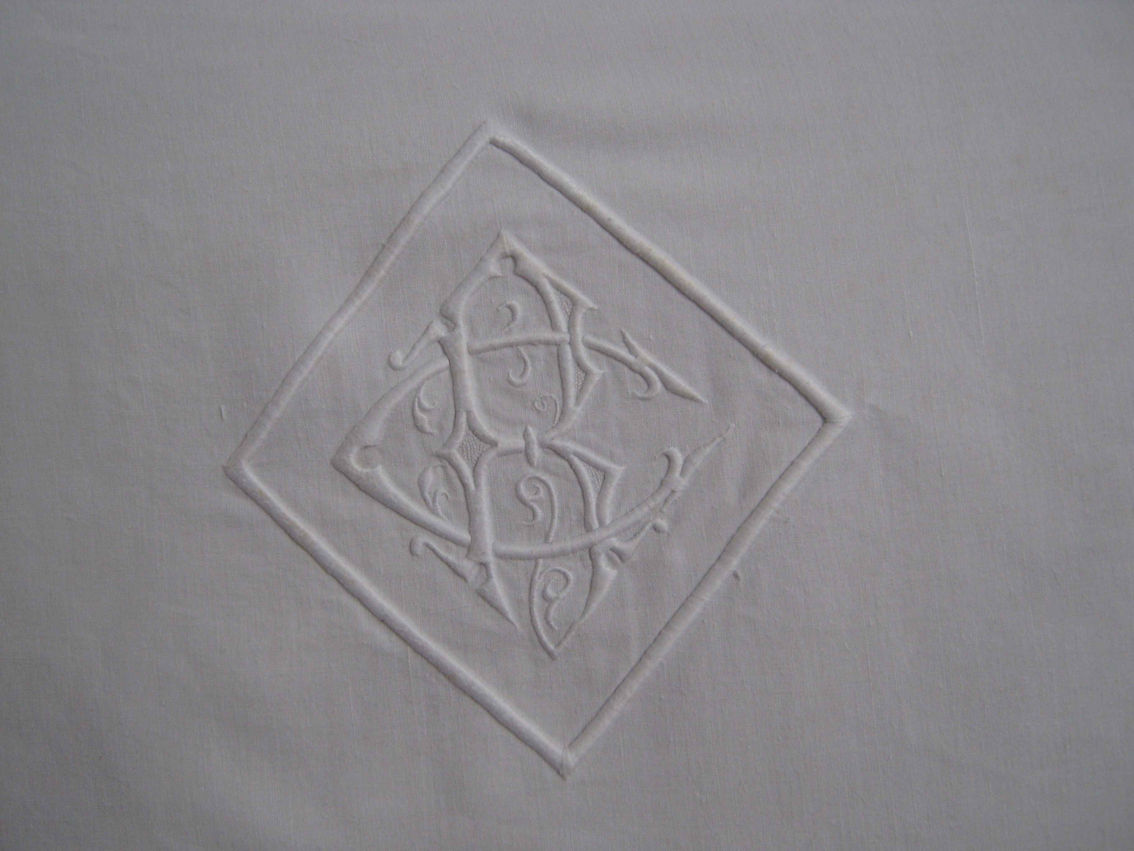 Old sheet in monogram white thread