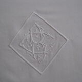 Old sheet in monogram white thread