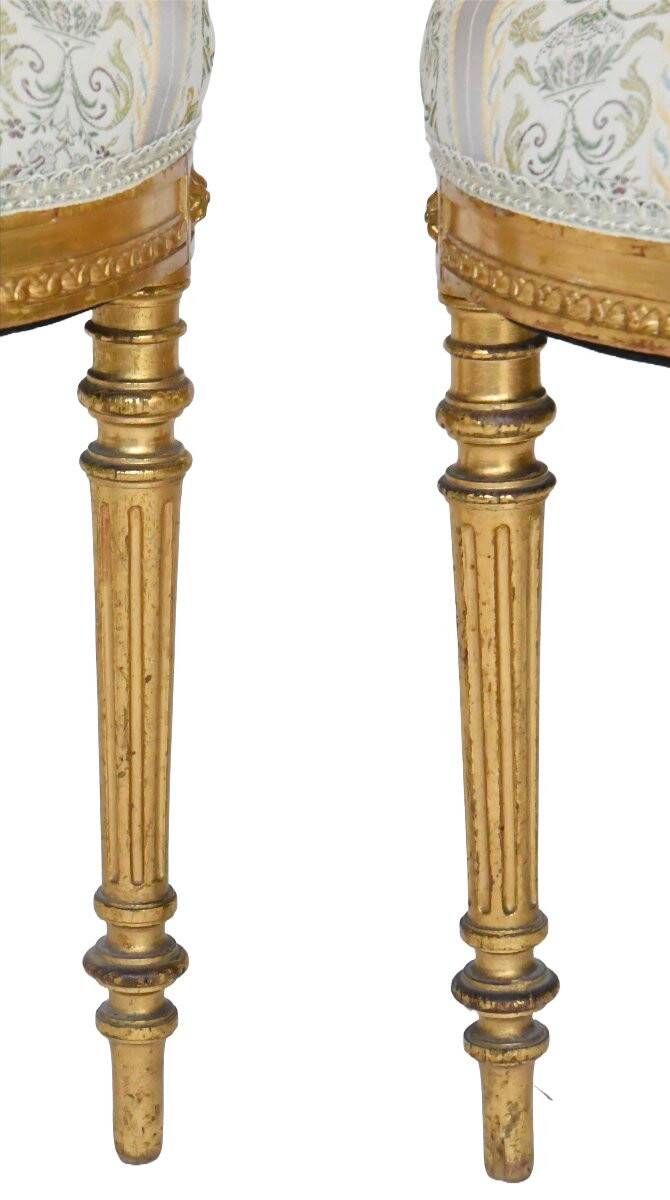 Pair of Louis XVI style chairs in gilded wood.