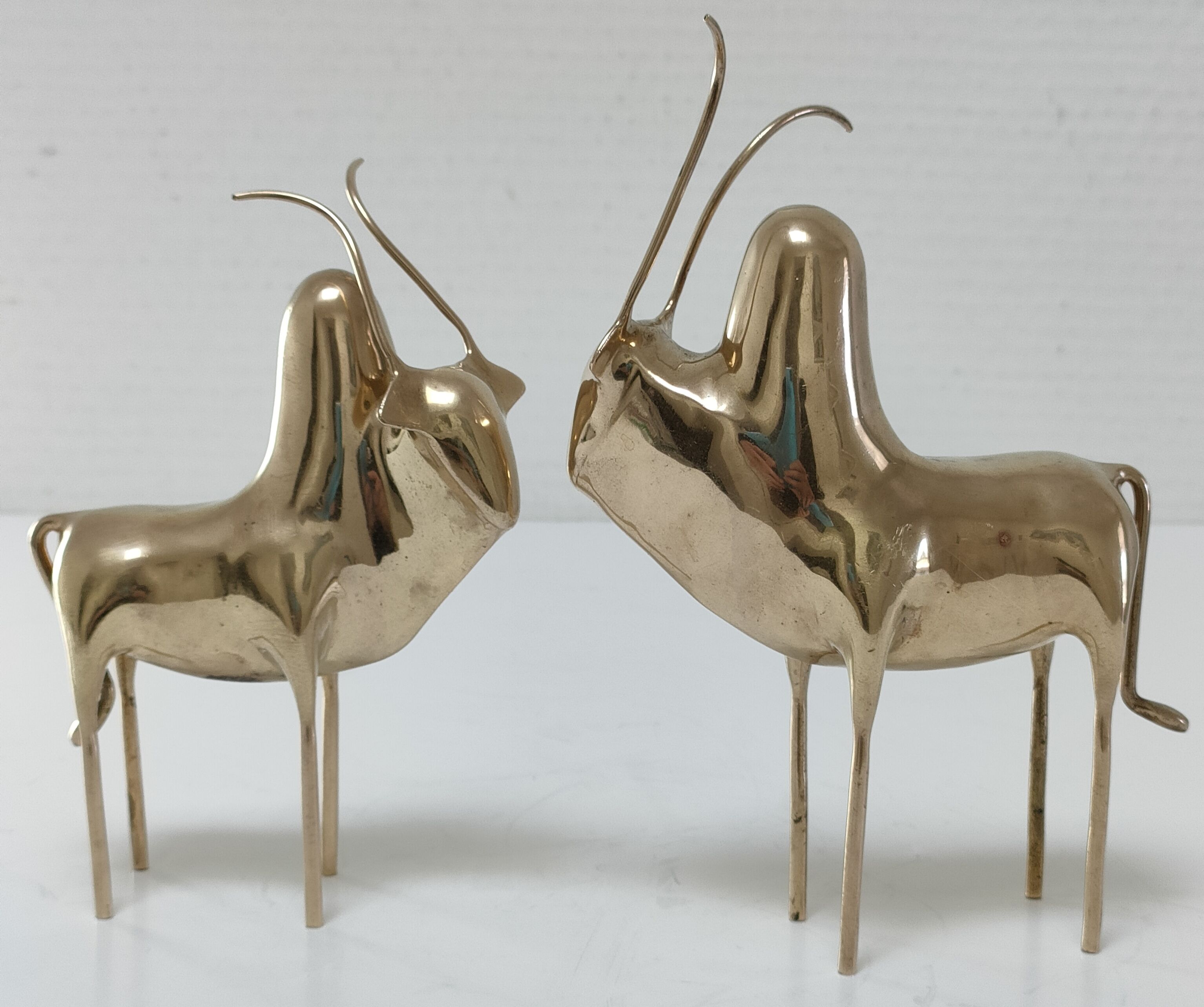 Two stylized zebu with long vintage brass horns