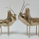 Two stylized zebu with long vintage brass horns